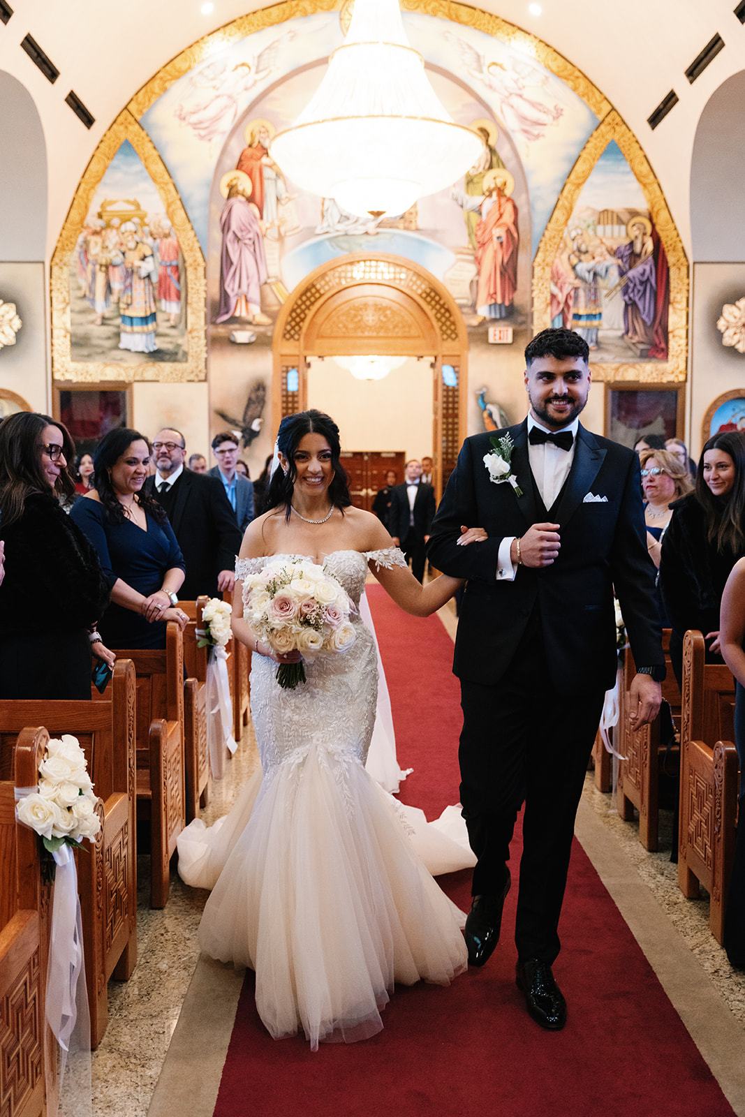 Newlyweds walking back down the aisle after their ceremony